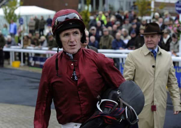 Champion jockey Tony McCoy shows his discomfort after riding his 150th winner of the season at Wetherby.
