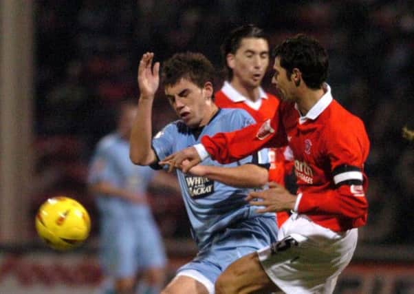 Flashback to 2004: Leeds United's Simon Walton is stopped in his tracks by Rotherham's Martin McIntosh.