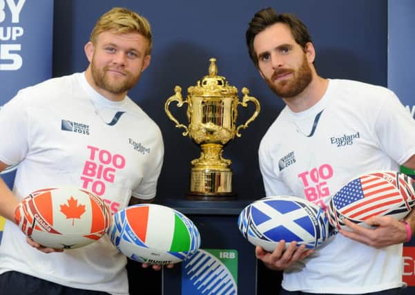 Yorkshire Carnegie players Lee Imiolek and Jon Clarke, with the Webb Ellis trophy at the Rugby World Cup 2015 volunteer Try Outs at Leeds Beckett University, Headingley Campus. (Picture: Bruce Rollinson)