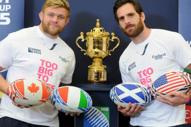 Yorkshire Carnegie players Lee Imiolek and Jon Clarke, with the Webb Ellis trophy at the Rugby World Cup 2015 volunteer Try Outs at Leeds Beckett University, Headingley Campus. (Picture: Bruce Rollinson)