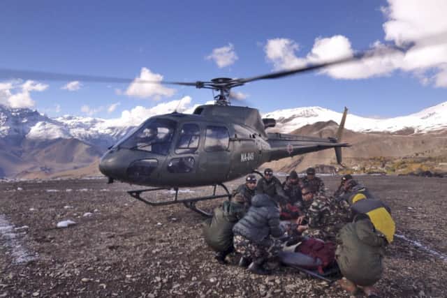 Soldiers carry avalanche victimsin Thorong La pass area, Nepal