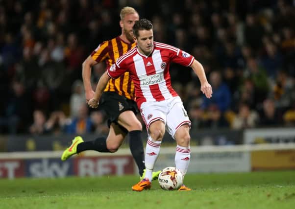 Marc McNulty slots home Sheffield United's second goal at Valley Parade. Picture: Martyn Harrison