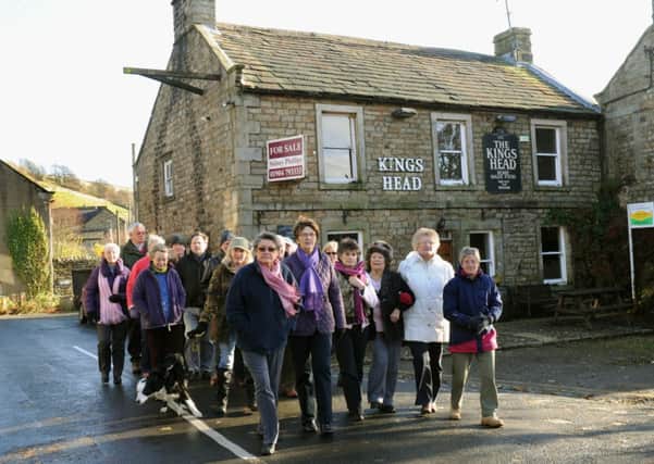 Locals from Gunnerside in Upper Swaledale outside the closed Kings Head pub