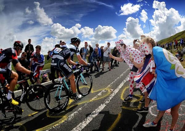 Fans cheer on cyclists as they tackle the Holme Moss climb on stage two of the Tour de France. Picture by Simon Hulme.