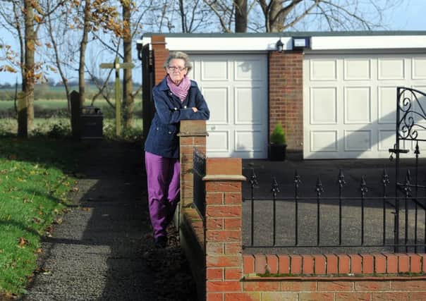 Pic: James Hardisty,  Janet and Barry Ashdown, from Sproatley, near Hull, are in dispute with East Riding Council over planning permission of their single garage, the driveway in front of it and the joining boundary wall that runs alongside a public footpath. The wall, garage and driveway was built over 30 years ago after the then home owners were given planning permission. Now the council has ordered Janet, three weeks to knock it down.