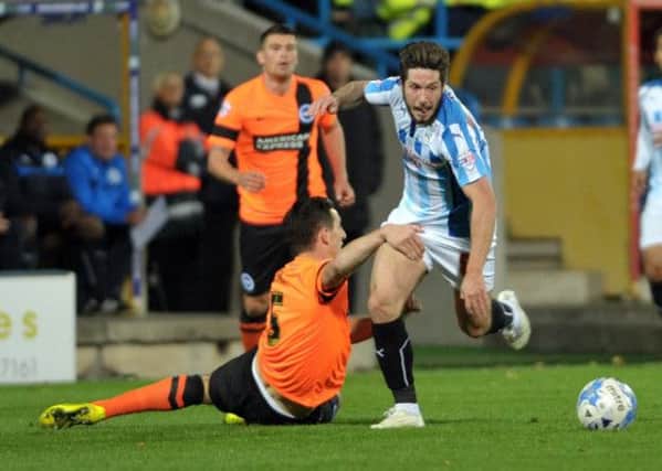 Jacob Butterfield of Huddersfield Town outpaces Lewis Dunk of Brighton and Hove Albion.
