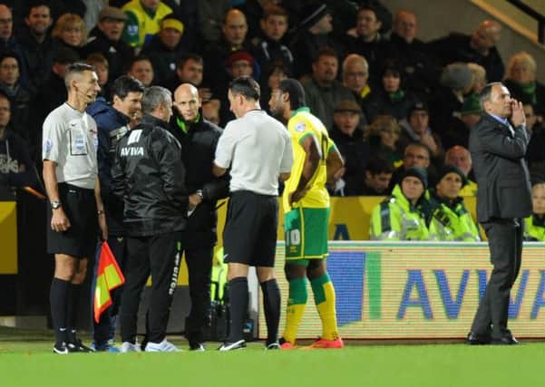 Cameron Jerome and referee Mark Clattenburg with with officials after clashing with Gaetano Berardi.  Picture by Bruce Rollinson