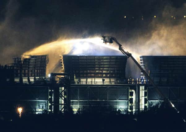 Fire crews spray water at the scene of the fire at Didcot Power Station in Oxfordshire.