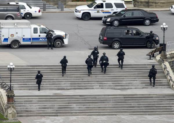 Police teams move towards Centre Block at Parliament Hill in Ottawa