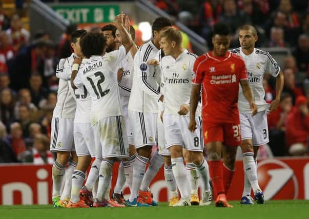 NO ANSWER: Real Madrid's Karim Benzema (fourth left) celebrates scoring his sides third goal against Liverpool on Wednesday night.