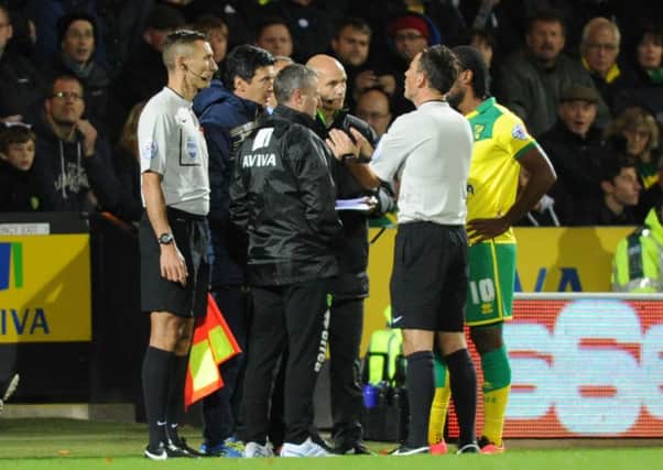 Mark Clattenburg and Cameron Jerome at Norwich on Tuesday night.