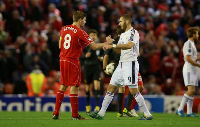 OUTCLASSED: Liverpool's Steven Gerrard congratulates Real Madrid's Karim Benzema at the final whistle at Anfield.