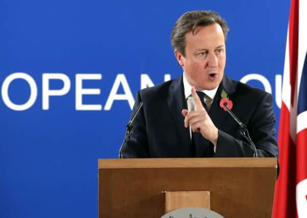 David Cameron speaks during a media conference after an EU summit at the EU Council building in Brussels