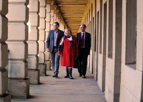 Councillor Marcus Thompson, cabinet member for communities, Fiona Spiers, of the Heritage Lottery Fund, and Michael Graham, of Graham Construction, at the Piece Hall, Halifax.  Picture: Bruce Rollinson