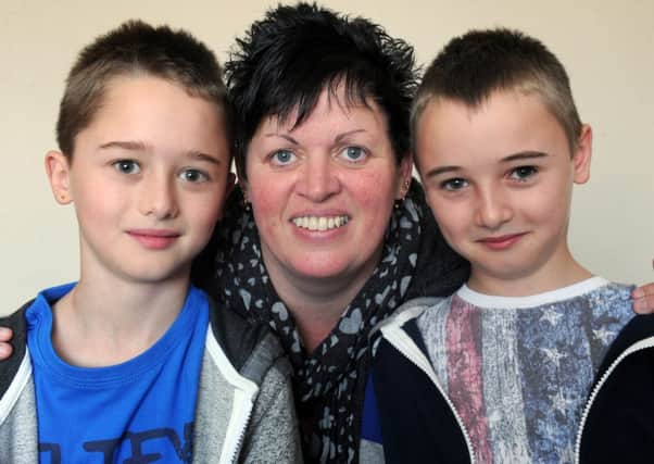 Maggie Wilby who had a stroke last year aged just 35.  pictured  twin sons  Oliver and Ben at their home in Middlestown