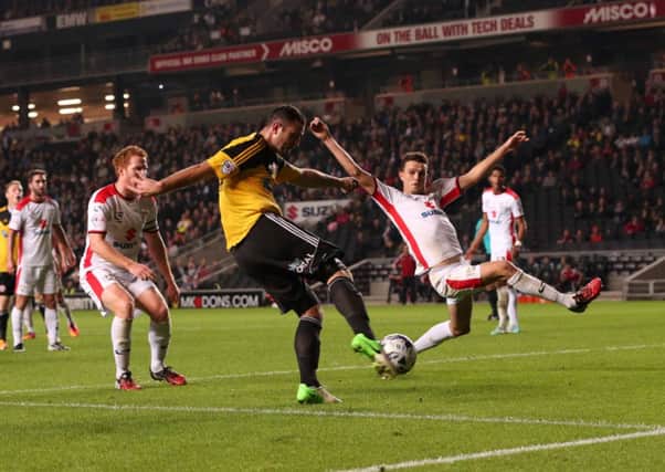 Michael Higdon slams home his and Sheffield Uniteds second goal against MK Dons last night (Picture: Martyn Harrison).