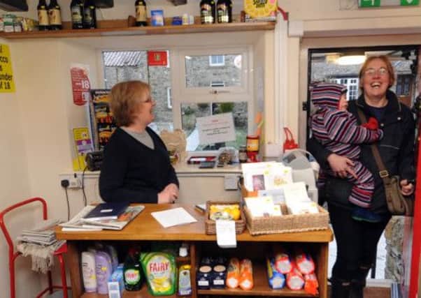 7th January 2011.
The Little Shop at the George and Dragon pub,  Hudswell near Richmond.
Pictured Lorna Chapman volunteer helper greets a customer on entering the Little Shop.
PICTURE GERARD BINKS