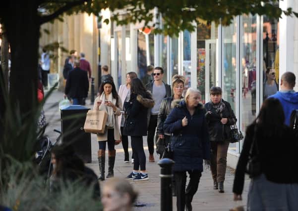 Shoppers in Harrogate enjoy the unseasonably mild weather today. 
Picture by Gerard Binks