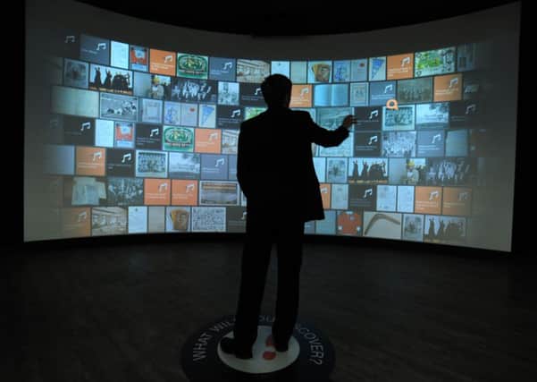 A visitor using the interactive wall at Heritage Quay