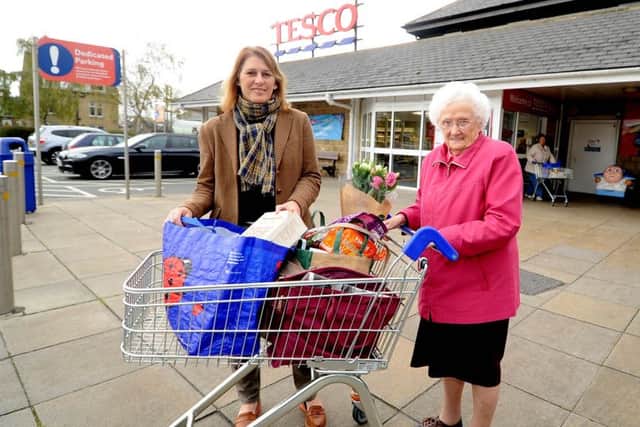 Karen Jones, 51, a volunteer for the Ilkley and District Good Neighbour Shop Assist scheme helps Shelia White, 88, shop at Tesco in Ilkley.