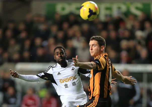 Hull City's Alex Bruce (right) and Swansea City's Nathan Dyer