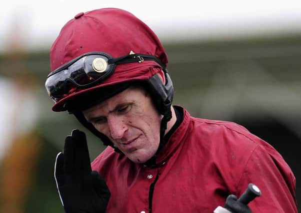 Champion jockey Tony McCoy shows his discomfort as he comes back to the Winners enclosure on Goodwood Mirage  after riding his 150th Winner of the season in the Read racinguk Columnists Hurdle Race at Wetherby Racecourse, Wetherby.
