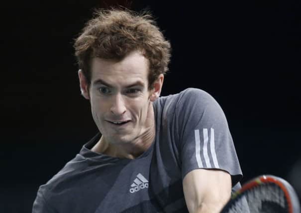 Andy Murray of Britain returns the ball to Novak Djokovic of Serbia during their quarter-final match in Paris.