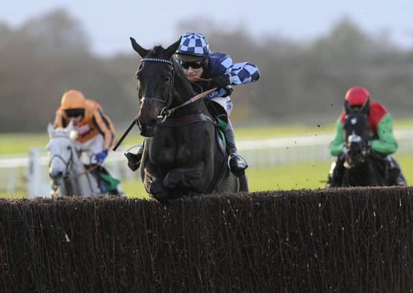 UPSETTING THE ODDS: Menorah and Richard Johnson jump the last fence before going on to win the bet365 Charlie Hall Chase at Wetherby. Picture: John Giles/PA