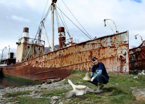 Picture shows the Viola trawler and bell at the abandoned whaling station at Grytviken, South Georgia. The bell is held by the Grytviken museum curator, Elsa Davidson