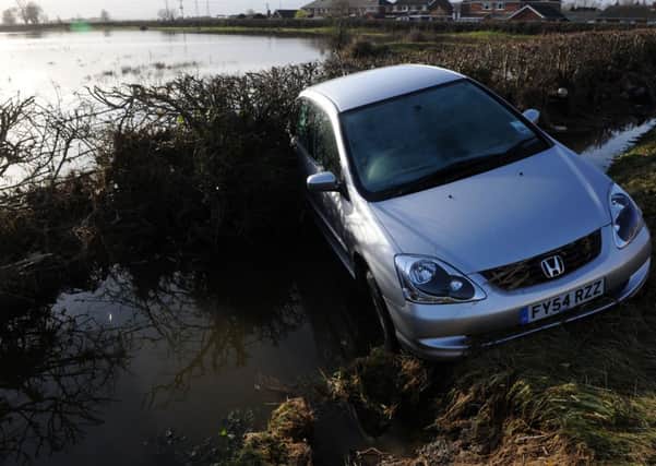 A car lies in a dyke in Sluice Road, South Ferriby following the December 2013 tidal surge