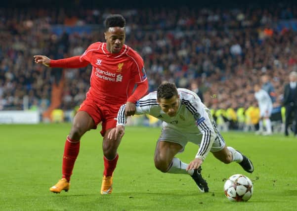 TOUGH GOING: Raheem Sterling and Ronaldo battle for possession at the Bernabeu.