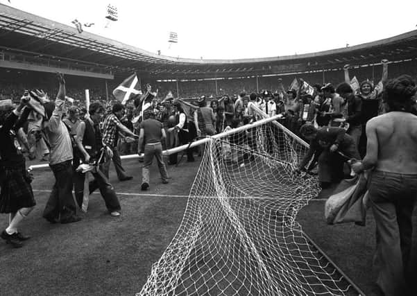 MEMORY LANE: A goal is smashed and torn down as thousands of Scottish fans run wild on the pitch at Wembley Stadium after Scotland's 2-1 victory over England in the Home Championship back in 1977.