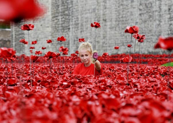 The ceramic poppies art installation 'Blood Swept Lands and Seas of Red' by artist Paul Cummins at the Tower of London