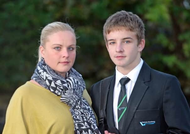 Picture shows Mason Beaumont (14) who was sent home from Hanson Academy in Bradford, West Yorkshire, along with another 151 pupils for wearing the incorrect school uniform. Pictured with outraged mum Lindsay Stansfield.  See Ross Parry copy RPYUNIFORM. An academy has sent home 152 pupils after they failed to meet the school's new strict uniform policy. Hanson Academy in Bradford, West Yorkshire, strictly enforced a new dress code on Tuesday and almost 10% of its pupils failed to meet the standards. A number of parents took to the school's Facebook page to complain about the 'harsh' new measures. 

Glen Minikin / rossparry.co.uk