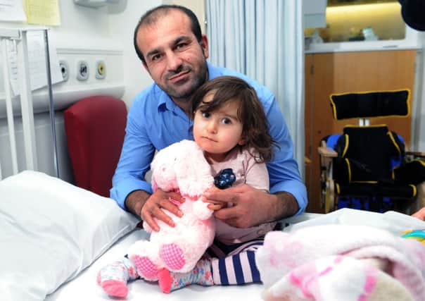 Abdulwaid Mosa with 19-month-old daughter Arda in hospital.