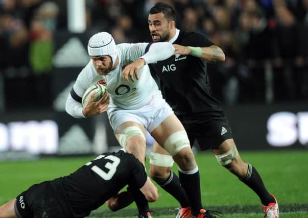 England's Dave Attwood is tackled by New Zealands Ryan Crotty