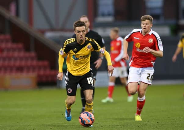 Crewe's James Jones and Sheffield United's Stefan Scougall compete for the ball.