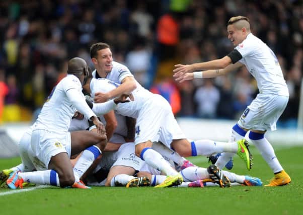 Leeds United's Liam Cooper is mobbed as he celebrates his goal against Blackpool (Picture: Jonathan Gawthorpe).