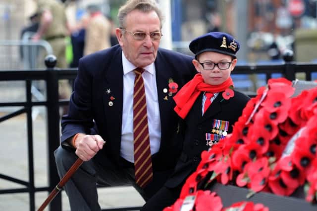 Six-year-old Harvey Roberts with his great-grandad Bill Ramsey look at the wreaths at the annual Leeds Remembrance Sunday service