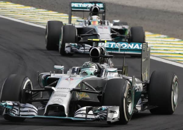 Mercedes driver Nico Rosberg of Germany, leads the race followed by teammate Lewis Hamilton of Britain, during the Formula One Brazilian Grand Prix at the Interlagos race track in Sao Paulo. (AP Photo/Andre Penner)