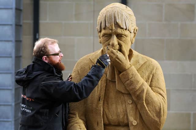 Artist Jamie Wardley putting the finishing touches to his sand sculpture 'Loss is Eternal' Picture by Bruce Rollinson