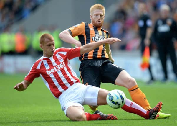 Hull City's Paul McShane battles for the ball with Stoke City's Steve Sidwell