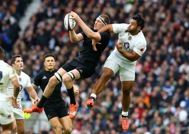 New Zealand's Brodie Retallick (left) is challenged by England's Billy Vunipola.