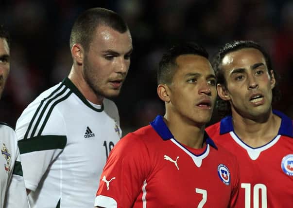 From left to right Corry Evans, Luke McCullough, of Northem Ireland and Chile's Alexis Sanchez and Jorge Valdivia during a friendly soccer match in Valparaiso, Chile, Wednesday, June 4, 2014. (AP Photo/Luis Hidalgo)