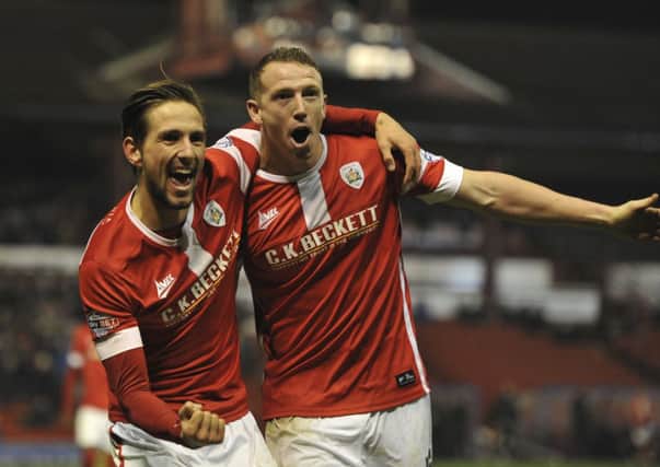 Conor Hourihane, left, celebrates with Peter Ramage after the latter scored what proved to be the winning goal for Barnsley against Colchester United (Picture: Keith Turner).