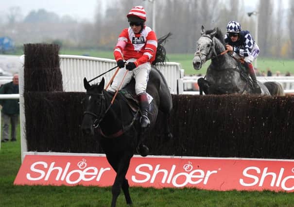 Dunraven Storm, ridden by Richard Johnson, jumps the last fence to win The Racing Post Arkle Trophy Trial Novices Steeple Chase
