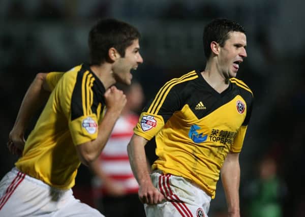 DERBY HERO: Jamie Murphy, right, shows his delight at scoring Sheffield Uniteds winner at Doncaster which has set them up nicely for tonights FA Cup replay. Picture: Martyn Harrison.