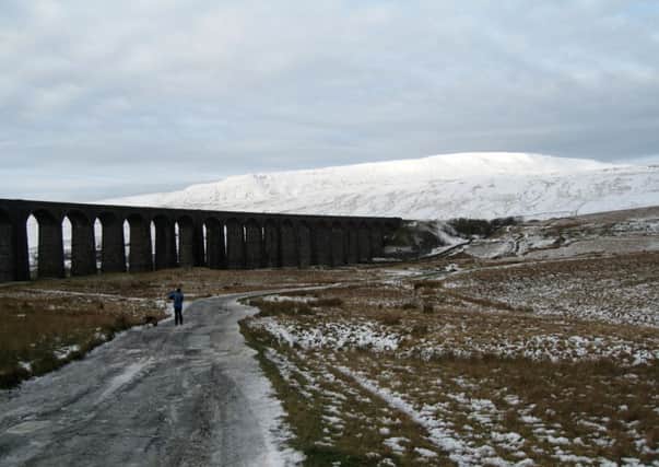 Whernside provides the backdrop to Ribblehead Viaduct.