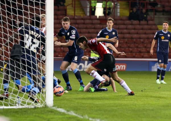DOUBLE UP: Ryan Flynn scores his and Sheffield United's first goal against Crewe.