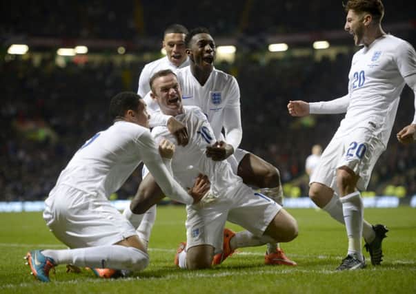 MAIN MAN: England's Wayne Rooney celebrates scoring his side's second goal at Celtic Park.